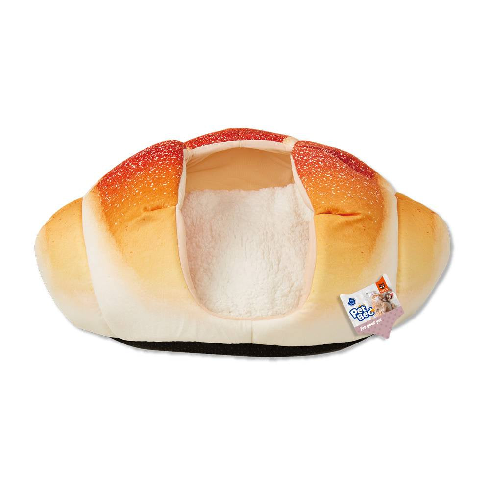 Plush pet bed like a croissant on a white background