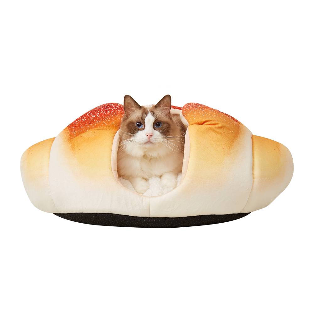 Cat inside a bread-shaped pet bed on a white background