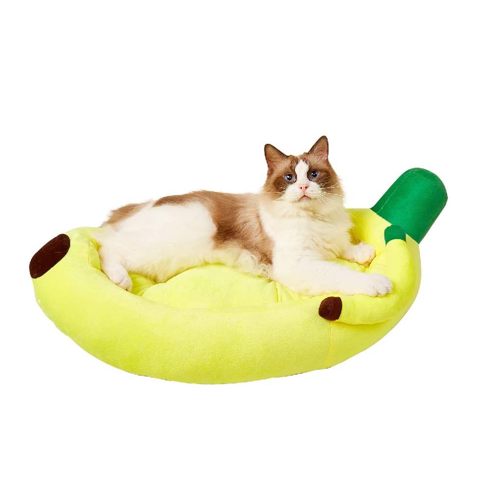 Cat lying on a banana-shaped pet bed with a white background